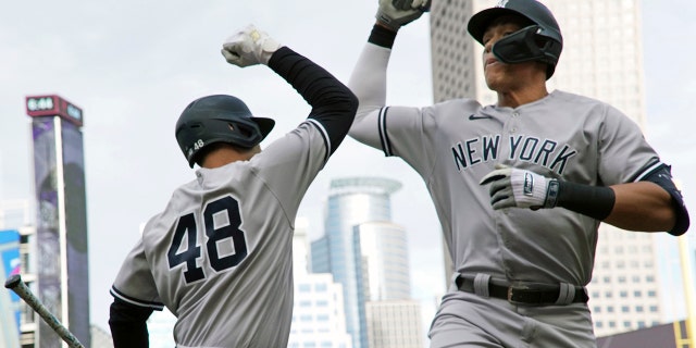 New York Yankees' Aaron Judge, right, and Anthony Rizzo celebrate a two-run home run by Judge off Minnesota Twins pitcher Cole Sands Tuesday, June 7, 2022, in Minneapolis.