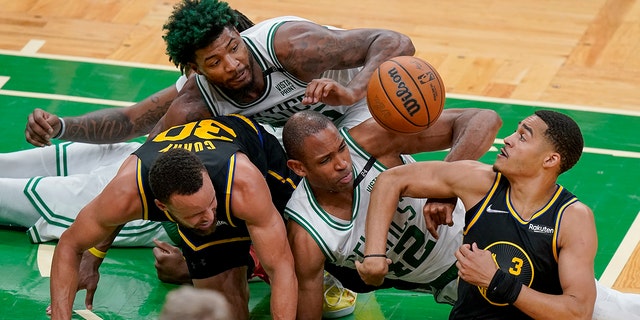 Boston Celtics center Al Horford (42) and guard Marcus Smart, top, battle for a loose ball against Golden State Warriors guard Jordan Poole (3) and guard Stephen Curry (30) during the fourth quarter of Game 3 of basketball's NBA Finals, Wednesday, June 8, 2022, in Boston.