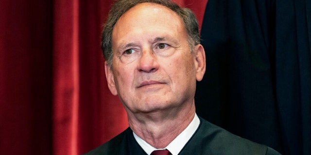 Deputy Judge Samuel Alito sits during a group photo at the Supreme Court in Washington on April 23, 2021. 