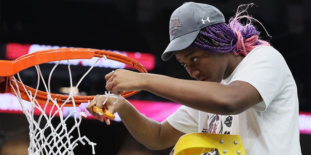 Aliyah Boston #4 of the South Carolina Gamecocks cuts down a piece of the net after defeating the UConn Huskies 64-49 during the 2022 NCAA Women's Basketball Tournament National Championship game at Target Center on April 03, 2022 in Minneapolis, Minnesota.