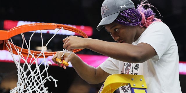 Aliyah Boston #4 of the South Carolina Gamecocks cuts down a piece of the net after defeating the UConn Huskies 64-49 during the 2022 NCAA Women's Basketball Tournament National Championship game at Target Center on April 03, 2022 in Minneapolis, Minnesota.