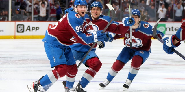 Andre Burakovsky, #95 of the Colorado Avalanche, celebrates with teammates after scoring a goal against Andrei Vasilevskiy, #88 of the Tampa Bay Lightning, during overtime to win Game One of the 2022 Stanley Cup Final 4-3 at Ball Arena on June 15, 2022 in Denver, Colorado.