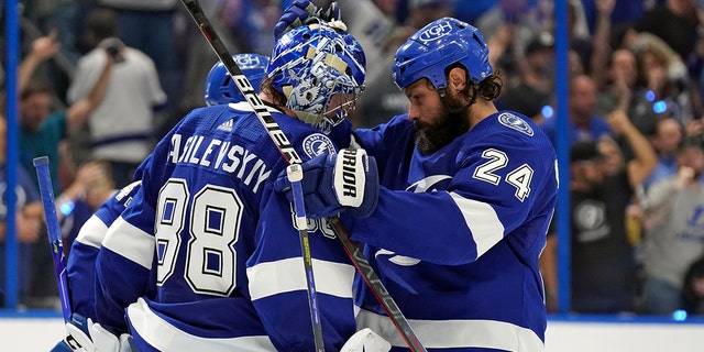 Tampa Bay Lightning goaltender Andrei Vasilevskiy (88) celebrates with defenseman Zach Bogosian (24) after the team defeated the New York Rangers during Game 4 of the NHL hockey Stanley Cup playoffs Eastern Conference finals Tuesday, June 7, 2022, in Tampa, Fla. 