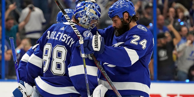 Tampa Bay Lightning goaltender Andrei Vasilevskiy (88) celebrates with defenseman Zach Bogosian (24) after the team defeated the New York Rangers during Game 4 of the NHL hockey Stanley Cup playoffs Eastern Conference finals Tuesday, June 7, 2022, in Tampa, Fla.
