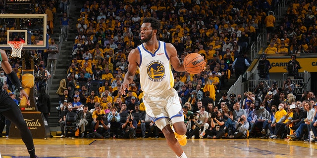 Andrew Wiggins of the Golden State Warriors dribbles the ball against the Boston Celtics during the NBA Finals on June 13, 2022, at Chase Center in San Francisco.