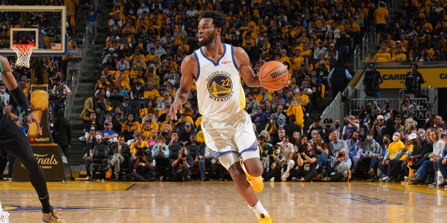 Andrew Wiggins of the Golden State Warriors dribbles the ball against the Boston Celtics during the NBA Finals on June 13, 2022, at Chase Center in San Francisco.