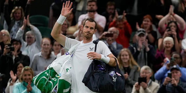 Britain's Andy Murray waves after losing the singles tennis match against John Isner of the US on day three of the Wimbledon tennis championships in London, Wednesday, June 29, 2022. 
