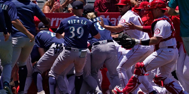 Several members of the Seattle Mariners and the Los Angeles Angels scuffle after Mariners' Jesse Winker was hit by a pitch during the second inning of a baseball game Sunday, June 26, 2022, in Anaheim, Calif. 