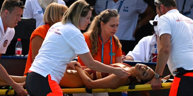 Anita Alvarez of United States is taken on a stretcher from the pool after collapsing during the solo free final of the artistic swimming at the 19th FINA World Championships in Budapest, Hungary, Wednesday, June 22, 2022.