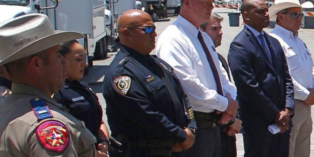 Uvalde School Police Chief Pete Arredondo, third from left, stands during a news conference outside Robb Elementary School in Uvalde, Texas, May 26, 2022.