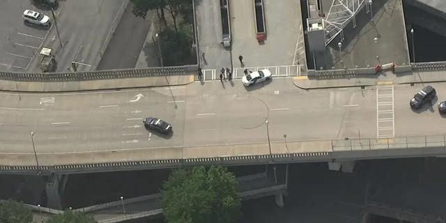 Police block a section of Ted Turner Drive in Atlanta after a report of a shooting involving a federal agent on Friday.