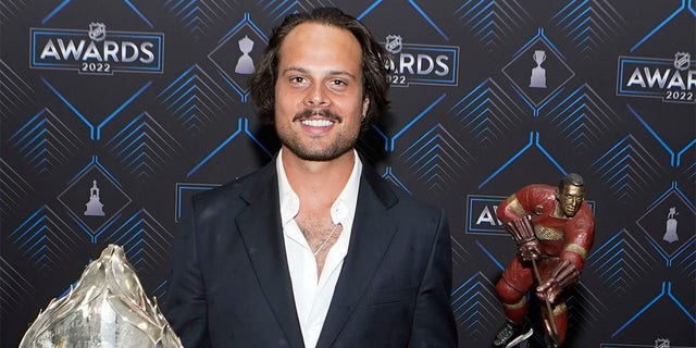 Toronto Maple Leafs center Auston Matthews poses with the Hart Trophy, left, and Ted Lindsay Award after the NHL hockey awards Tuesday, June 21, 2022, in Tampa, Fla. The Hart Trophy is presented annually to the leagues' most valuable player and the Ted Lindsay award is giving the the most outstanding player. 