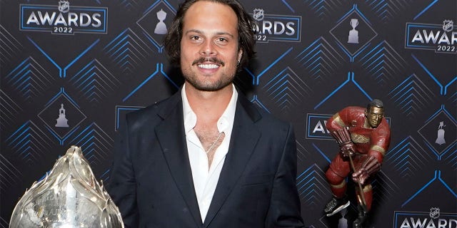 Toronto Maple Leafs center Auston Matthews poses with the Hart Trophy, left, and Ted Lindsay Award after the NHL hockey awards Tuesday, June 21, 2022, in Tampa, Fla. The Hart Trophy is presented annually to the leagues' most valuable player and the Ted Lindsay award is giving the the most outstanding player. 