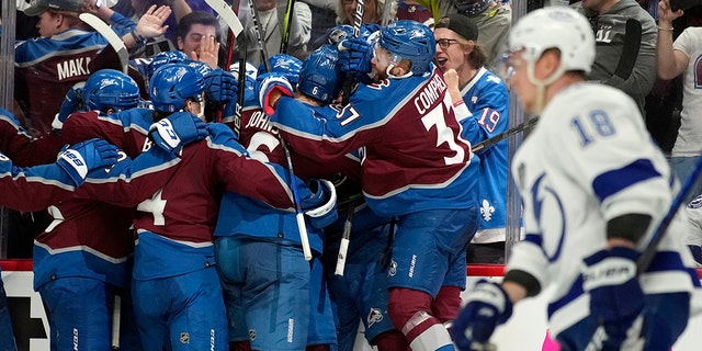 The Colorado Avalanche celebrate after an overtime goal by Andre Burakovsky in Game 1 of the NHL hockey Stanley Cup Final against the Tampa Bay Lightning on Wednesday, Junie 15, 2022, in Denver.