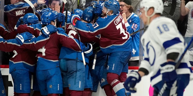 The Colorado Avalanche celebrate after an overtime goal by Andre Burakovsky in Game 1 of the NHL hockey Stanley Cup Final against the Tampa Bay Lightning on Wednesday, June 15, 2022, in Denver.