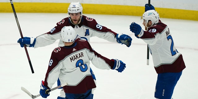 Colorado Avalanche right wing Mikko Rantanen (96), center Nathan MacKinnon (29) and defenseman Cale Makar (8) celebrate after a goal during the second period of Game 4 of the NHL hockey Stanley Cup Finals against the Tampa Bay Lightning on Wednesday, June 22, 2022, in Tampa, Fla.