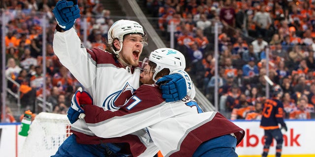Colorado Avalanche left wing J.T. Compher (37) celebrates his goal against the Edmonton Oilers with Bowen Byram (4) during the third period of Game 3 of the NHL hockey Stanley Cup playoffs Western Conference finals, Saturday, June 4, 2022, in Edmonton, Alberta. (Jason Franson/The Canadian Press via AP)