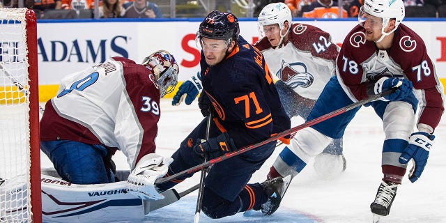 Colorado Avalanche goalie Pavel Francouz (39) is crashed into by Edmonton Oilers' Ryan McLeod (71) as Avalanche center Nico Sturm (78) defends during the second period of Game 3 of the NHL hockey Stanley Cup playoffs Western Conference finals, Saturday, June 4, 2022, in Edmonton, Alberta. (Jason Franson/The Canadian Press via AP)