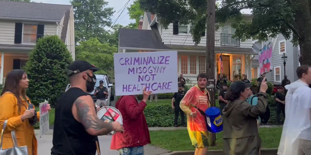 Protesters and drummers marched past Kavanaugh's home after an alleged assassination attempt.