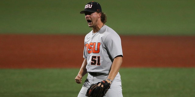 Oregon State pitcher Ben Ferrer celebrates his team's 4-3 win over Auburn in an NCAA college baseball tournament super regional game on Sunday, June 12, 2022, in Corvallis, Ore. 