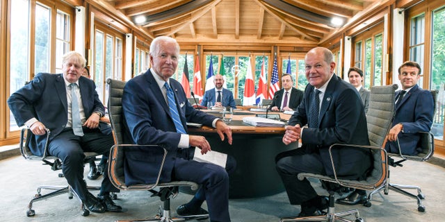 U.S. President Joe Biden, center, attends a working lunch with other G7 leaders to discuss shaping the global economy.  Clockwise from left, Fumio Kishida (covered), Prime Minister of Japan, Ursula von der Leyen (covered), President of the European Commission, Charles Michel, President of the European Council, Mario Draghi, Prime Minister of Italy, Justin Trudeau, Prime Minister of Canada, Emmanuel Macron, Prime Minister of France, German Chancellor Olaf Scholz, US President Joe Biden and Boris Johnson, Prime Minister of the United Kingdom sit at the first working session in Castle Elmau, in Elmau, Germany, Sunday, June 26, 2022. The Group of Seven leading economic powers are meeting in Germany for their annual gathering Sunday through Tuesday. (Kenny Holston/The New York Times via AP, Pool)