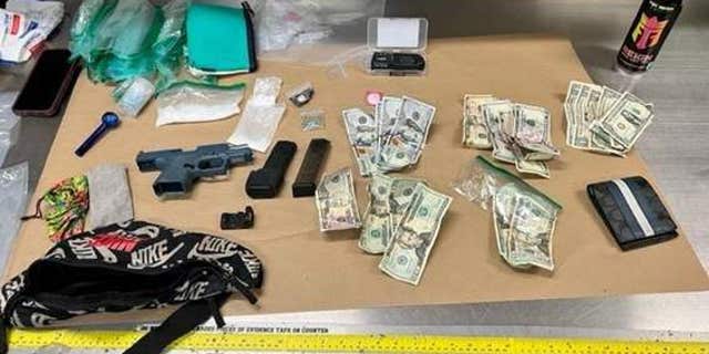 An Escondido police photo shows the alleged ghost gun, fentanyl, cash and other items seized from Blas during his arrest in May.