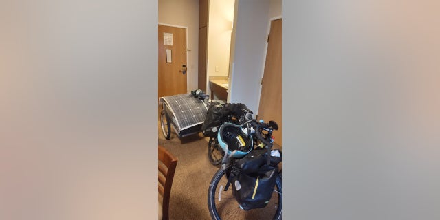 Barnes' bicycle and trailer are pictured in a hotel room where Barnes spent the night in Michigan.