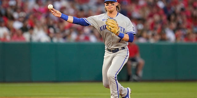 Kansas City Royals shortstop Bobby Witt Jr (7) throws to first dismissal during the third inning of a baseball game in Anaheim, Calif., Wednesday, June 22, 2022, to Andrew Velazquez of the Los Angeles Angels. 