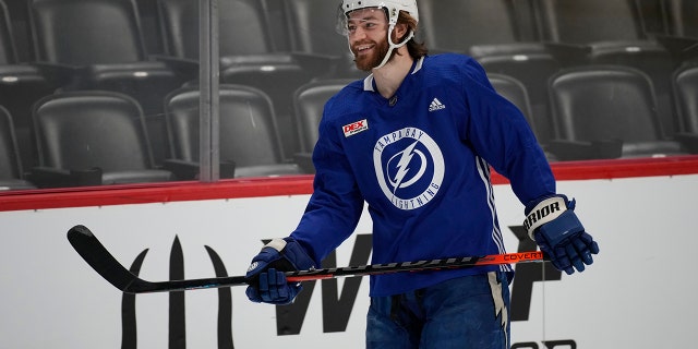 Tampa Bay Lightning center Brayden Point jokes with teammates during practice in Denver on June 14, 2022. 