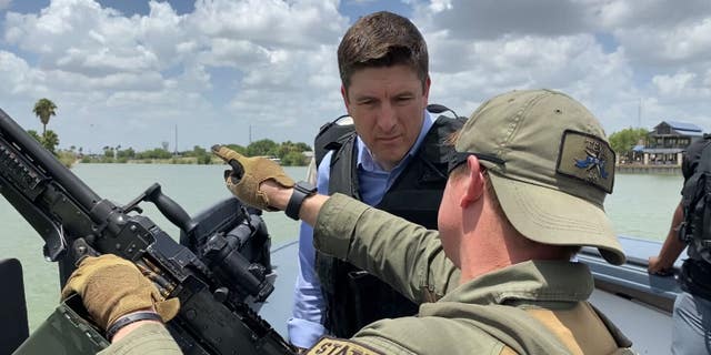 House Select Committee on Economic Disparity and Fairness in Growth Ranking Member Bryan Stiel, R-Wis., speaks with a Texas Department of Public Safety trooper on a boat patrolling the Rio Grande on June 17, 2022. 