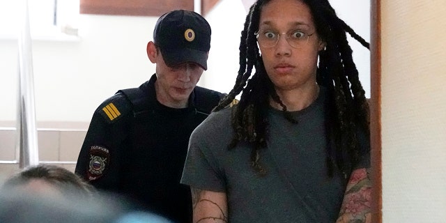 WNBA star and two-time Olympic gold medalist Brittney Griner is escorted to a courtroom for a hearing, in Khimki just outside Moscow, Russia, Monday, June 27, 2022.