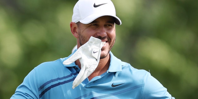  Brooks Koepka of the United States smiles on the eighth tee during a practice round prior to the 2022 U.S. Open at The Country Club on June 13, 2022 in Brookline, Massachusetts.