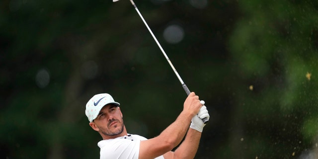 Brooks Koepka watches his shot on the 11th hole during the second round of the U.S. Open golf tournament at The Country Club, Friday, June 17, 2022, in Brookline, Mass.