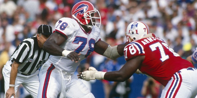 Bruce Smith #78 of the Buffalo Bills rushes a New England Patriot  opponent in a NFL football game at Foxboro Stadium in Foxboro, Massachusetts.