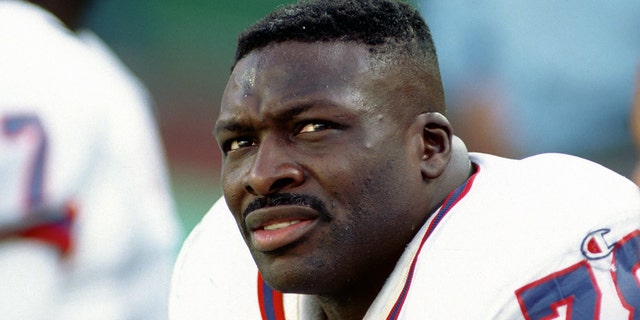 Defensive lineman Bruce Smith #78 of the Buffalo Bills looks on from the sideline during a game against the New York Jets at Giants Stadium on October 24, 1993 in East Rutherford, New Jersey.