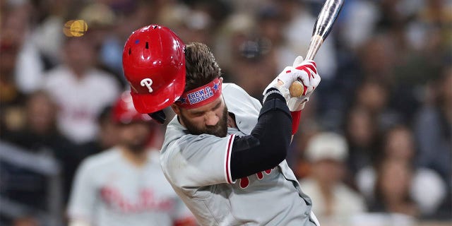 Philadelphia Phillies' Bryce Harper reacts after being hit by a pitch from San Diego Padres' Blake Snell during the fourth inning of a baseball game Saturday, June 25, 2022, in San Diego. 