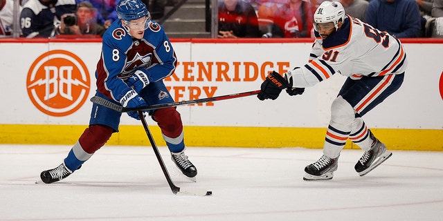 Avalanche defenseman Kale Capricorn controls the puck against Evander Kane of the Edmonton Oilers during the Stanley Cup playoffs at Ball Arena on June 2, 2022 in Denver, Colorado.