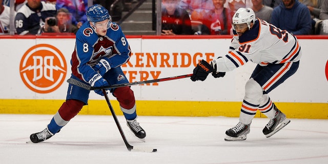 Avalanche defenseman Cale Makar controls the puck against Edmonton Oilers' Evander Kane during the Stanley Cup playoffs at Ball Arena on June 2, 2022, in Denver, Colorado.