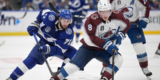 Colorado Avalanche defenseman Cale Makar (8) controls the puck next to Tampa Bay Lightning center Anthony Cirelli (71) during the third period of Game 4 of the NHL hockey Stanley Cup Finals on Wednesday, June 22, 2022, in Tampa, Fla. 