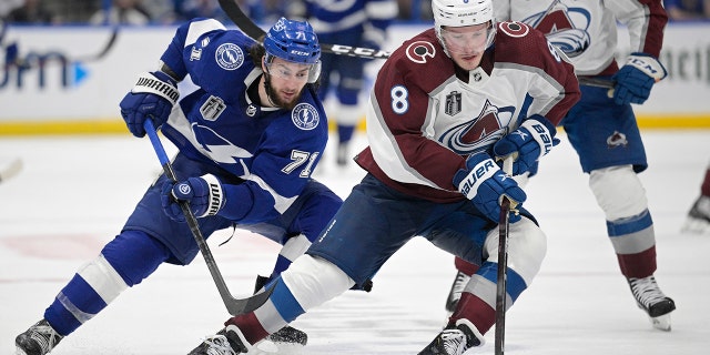 Colorado Avalanche defenseman Cale Makar (8) controls the puck next to Tampa Bay Lightning center Anthony Cirelli (71) during the third period of Game 4 of the NHL hockey Stanley Cup Finals on Wednesday, June 22, 2022, in Tampa, Fla.