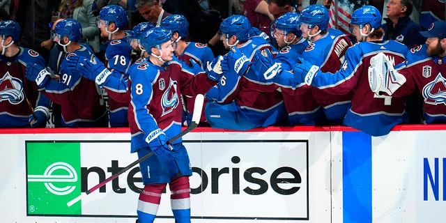 Colorado Avalanche defenseman Cale Makar (8) is congratulated for his goal against the Tampa Bay Lightning during the third period in Game 5 of the NHL hockey Stanley Cup Final, Friday, June 24, 2022, in Denver. 