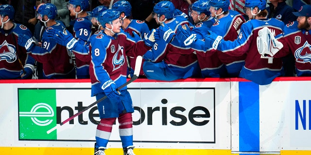 Colorado Avalanche defenseman Cale Makar (8) is congratulated for his goal against the Tampa Bay Lightning during the third period in Game 5 of the NHL hockey Stanley Cup Final, Friday, June 24, 2022, in Denver. 