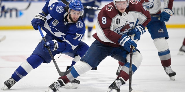 Colorado Avalanche defenseman Cale Makar (8) controls the puck next to Tampa Bay Lightning center Anthony Cirelli (71) during the third period of Game 4 of the NHL hockey Stanley Cup Finals on Wednesday, June 22, 2022, in Tampa, Fla. 