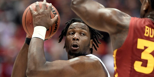 During the NCAA Men's Basketball Championship match in Milwaukee, Wisconsin on March 18, 2017, paddew boiler maker forward Caleb Swanigan prepared to dunk basketball against Iowa State Cyclone.