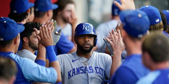 Kansas City Royals' Carlos Santana (41) returns to the dugout after hitting a home run during the fourth inning of a baseball game against the Los Angeles Angels in Anaheim, Calif., Tuesday, June 21, 2022. Hunter Dozier also scored. (AP Photo/Ashley Landis)