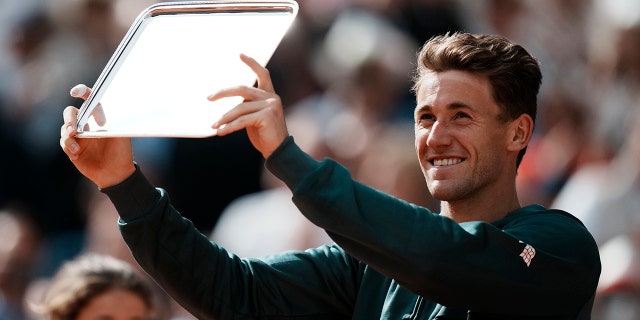 Norway's Casper Ruud shows his trophy after losing to Spain's Rafael Nadal in their final match of the French Open tennis tournament at the Roland Garros stadium Sunday, June 5, 2022 in Paris. Nadal won 6-3, 6-3, 6-0.