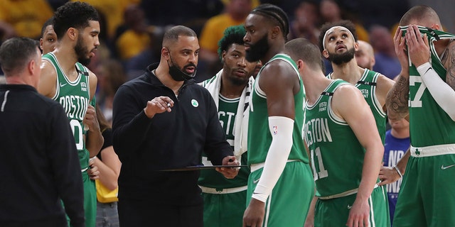 Boston Celtics head coach Ime Udoka, center left, talks to players during the first half of Game 2 of the NBA Finals of basketball against the Golden State Warriors in San Francisco, Sunday, June 5, 2022.