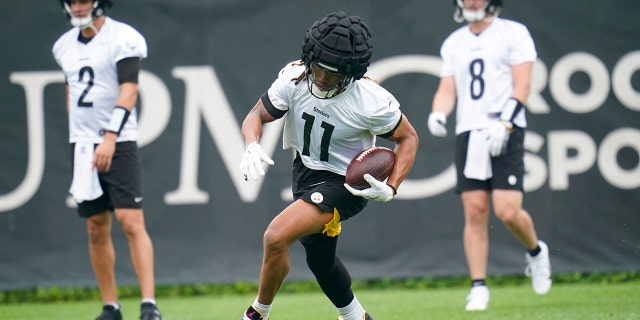 Steelers wide receiver Chase Claypool runs after catching a pass during a practice drill, June 7, 2022, in Pittsburgh.