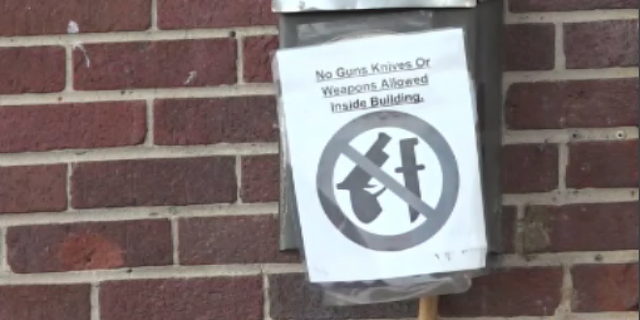 A sign is hung outside a business in Chattanooga, Tennessee, near the scene of a shooting that left three people dead and 14 others injured on Sunday.