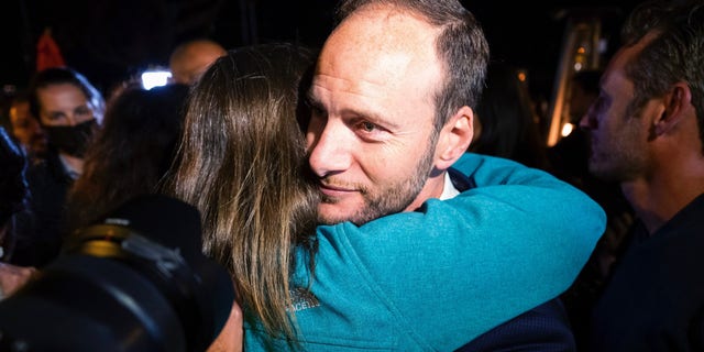 San Francisco District Attorney Chesa Boudin hugs a supporter Tuesday, June 7, 2022, in San Francisco. (AP Photo/Noah Berger)